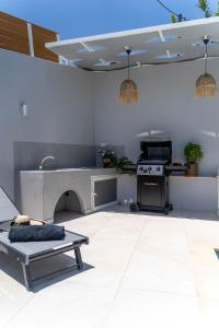 a kitchen with a table and a stove at Villa Venetia with Jacuzzi in Lambiní