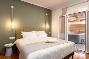 a bedroom with a large bed and a bathroom at Villa Venetia with Jacuzzi in Lambiní
