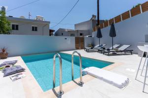 a swimming pool in the middle of a house at Villa Venetia with Jacuzzi in Lambiní