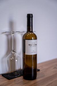 a bottle of wine sitting next to a wine glass at Island City Boutique Hotel in Rhodes Town