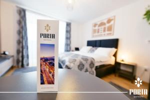 a hotel room with a table and a bed at Porta Apartman Sarajevo in Sarajevo +2 photos
