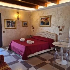 a bedroom with a bed with two pigs on it at Colle Indaco Wine Resort & Spa in Ortezzano