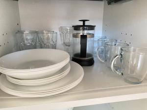 a kitchen counter with plates and glasses on it at A Morze Ustka in Ustka