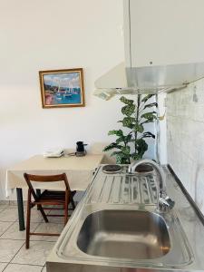 a kitchen with a sink and a table at GIALOS Rooms in Elafonisos