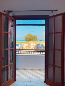 an open door with a view of a car outside at GIALOS Rooms in Elafonisos