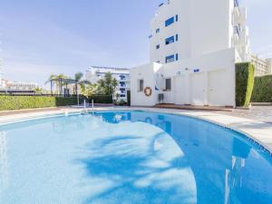 Una gran piscina azul frente a un edificio en FUNNY FRIENDLY FISH HOLIDAY APARTMENTS, en Benalmádena