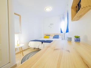 Un dormitorio con una cama y una mesa en una habitación. en FUNNY FRIENDLY FISH HOLIDAY APARTMENTS, en Benalmádena