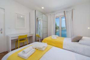 Postel nebo postele na pokoji v ubytování Apartments Ema
