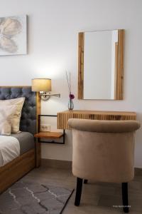 a bedroom with a bed and a chair at Secret Escape in Rovinj