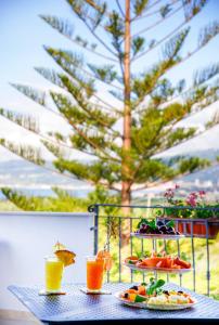 a table with two plates of food and two drinks at Residenza Anna Calabria in Briatico