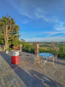 a table and chairs on a patio with a view at B&B La Buonora in Sinio