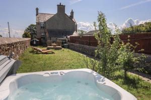 a bath tub in the yard of a house at The Old School House in Bodorgan