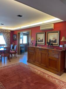 a living room with red walls and a dining room at PLAYA AMERICA MAR in Nigrán +18 photos