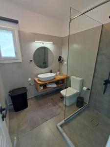 a bathroom with a shower and a toilet and a sink at sea melody tinos 2 in Agios Sostis +80 photos
