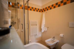 een badkamer met een douche, een wastafel en een toilet bij Casa dello Studente in Vittorio Veneto