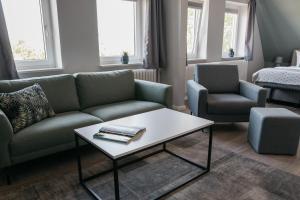 a living room with a couch and a coffee table at Schlei Hotel in Kappeln