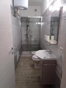 a bathroom with a shower and a toilet and a sink at B&B Villa Nora in Quartu SantʼElena