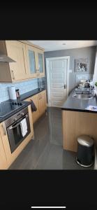 a kitchen with a sink and a stove at Sea View Terrace in Donaghadee