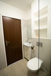 a bathroom with a toilet and a sink at HOTEL N Residence in Timişoara