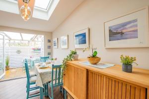 a kitchen and dining room with a table and chairs at Cosy Retreat in The City Centre in Galway