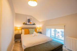 a bedroom with a large white bed with a window at Cosy Retreat in The City Centre in Galway