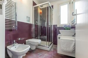 Un baño con inodoro, lavabo y ducha. en Palermo Modern Apartment with Swimming Pool, en Palermo 7 fotos más