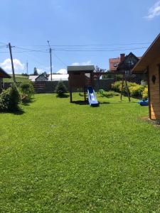 a playground with a slide in a yard at Zamajerz Nad Zalewem in Niedzica Zamek