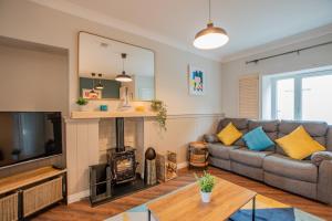 a living room with a couch and a fireplace at Cosy Retreat in The City Centre in Galway