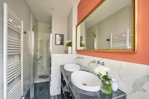 a bathroom with a sink and a mirror at La Maison Bordeaux in Bordeaux