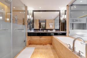 a large bathroom with a tub and a shower at Sheraton Zhongshan Hotel in Zhongshan