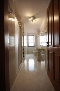 a large bathroom with a toilet and a sink at B&B Linu Ruiu in Santu Lussurgiu