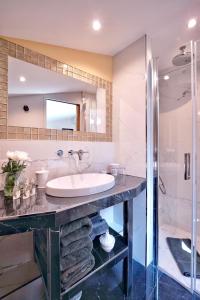 a bathroom with a sink and a shower at La Maison Bordeaux in Bordeaux