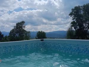 a swimming pool with a view of mountains at Sunny Bear Bed & Breakfast in Jelenia Góra