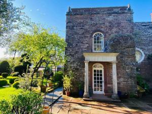 a brick building with a window and a garden at Country Estate Living 2bed1bath in Silloth