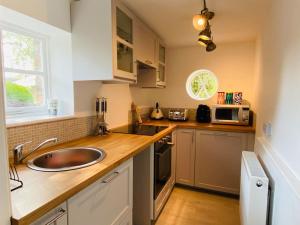 a kitchen with a sink and a counter top at Country Estate Living 2bed1bath in Silloth