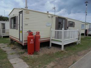 two red fire hydrants in front of a caravan at Promenade: Retreat:- 4 Berth, Access to the beach in Ingoldmells