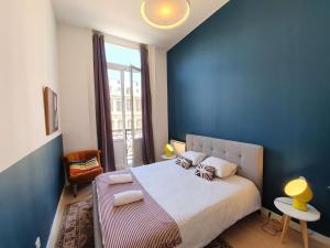 a bedroom with a large bed with a blue wall at Lille Centre Ville, Beaux Arts et Grand Palais, Bienvenue chez Nestyou Lille in Lille