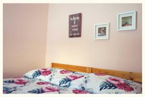 a bedroom with a bed with a floral comforter at Ingrid's Guesthouse Gartenidylle in Spittal an der Drau