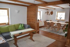 a living room with a couch and a table at Chalet Reiterhäusl in Ramsau am Dachstein