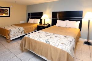 a hotel room with two beds and two lamps at Blue Marlin Motel in Virginia Beach
