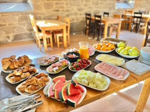 a table with many plates of food on it at Hotel Rural O Salazón in Cambados