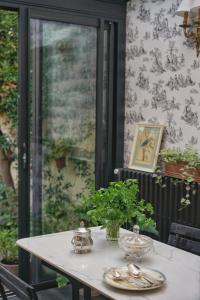 a table with plates and bowls on top of it at La Maison Bordeaux in Bordeaux
