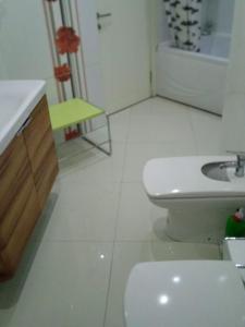 a white bathroom with a sink and a toilet at Апартаметы Либия Libiya в центре Кемера дуплекс две спальни, 140 кв м, 300 м до пляжа,рамещение до 5 человек in Kemer