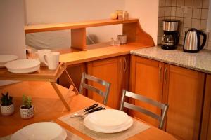 a kitchen with a table with plates on it at Nik apartment in Ierapetra