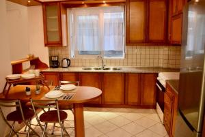 a kitchen with a table and chairs and a sink at Nik apartment in Ierapetra