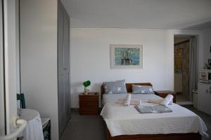 a bedroom with a bed with white sheets and pillows at Pines & Sea Studio in Áyioi