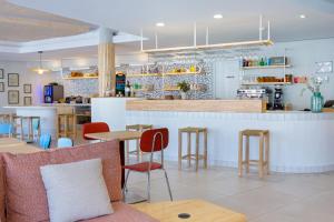 a restaurant with tables and chairs and a counter at ibis Styles Salon de Provence in Salon-de-Provence