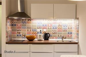 a kitchen with a counter with a tile back splash at Appartement Sportwerk in Göstling an der Ybbs