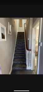 a staircase in a house with a stair case at Sea View Terrace in Donaghadee