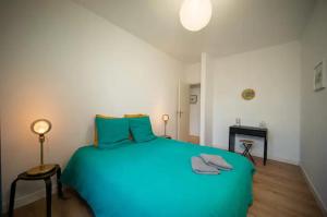 una camera con un grande letto blu di Magnifique Appartement T4 90 M2 très bien situé 2 min Vieux port et Gare St Charles a Marsiglia